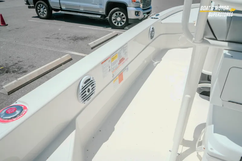 Slide: The Image of 2026 Skeeter SX221 boat interior with speakers and seating in a parking lot. - 15