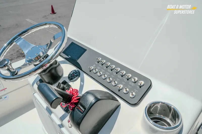 Slide: The Image of 2026 Skeeter SX221 boat console with steering wheel and control panel. - 16