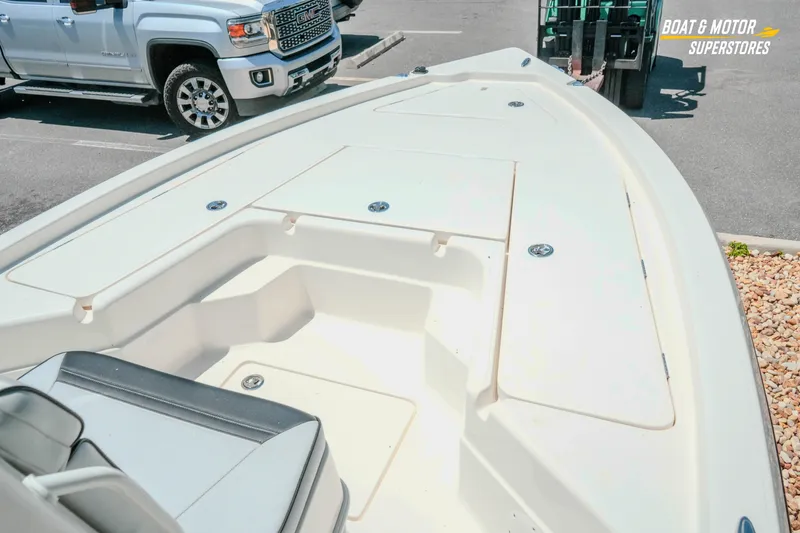 Slide: The Image of 2026 Skeeter SX221 boat deck in parking lot, near a white truck. - 17