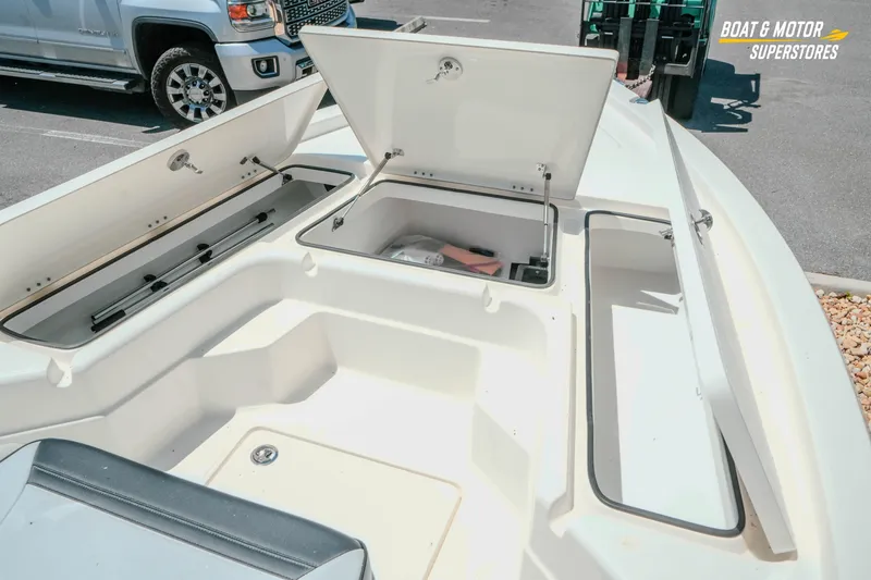 Slide: The Image of 2026 Skeeter SX221 boat storage compartments open, showcasing spacious interior design. - 19