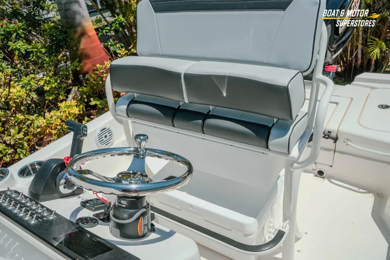 Slide: The Image of 2026 Skeeter SX221 boat interior with steering wheel and cushioned seating. - 24