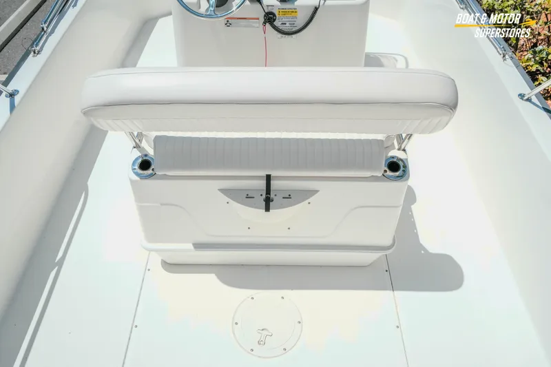 Slide: The Image of 2016 Boston Whaler 210 Montauk boat interior with white seating and steering console. - 13