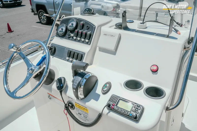 Slide: The Image of 2016 Boston Whaler 210 Montauk boat dashboard with steering wheel and control panel. - 16
