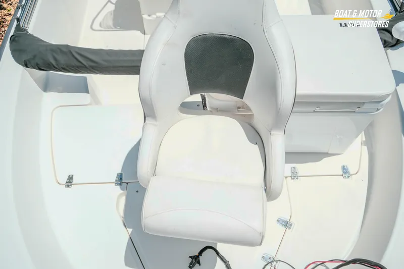 Slide: The Image of 2016 Boston Whaler 210 Montauk boat interior with white seating and storage compartment. - 20