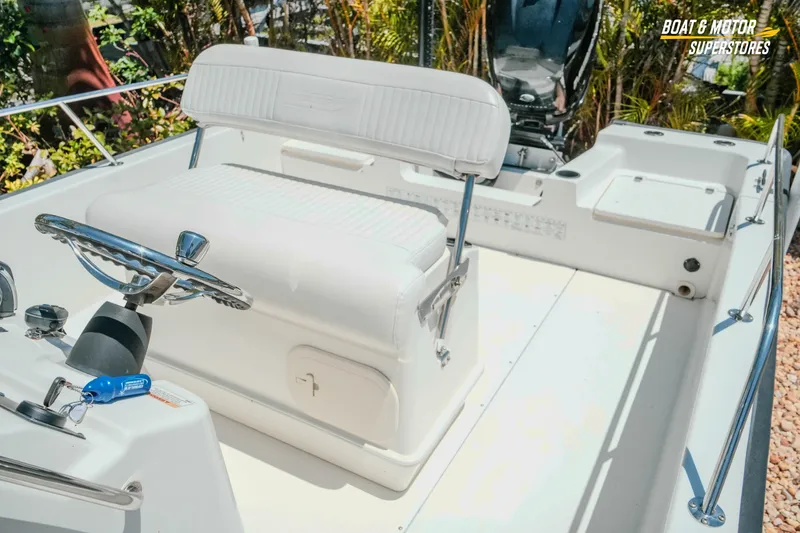 Slide: The Image of 2016 Boston Whaler 210 Montauk boat interior with steering wheel and seating. - 25