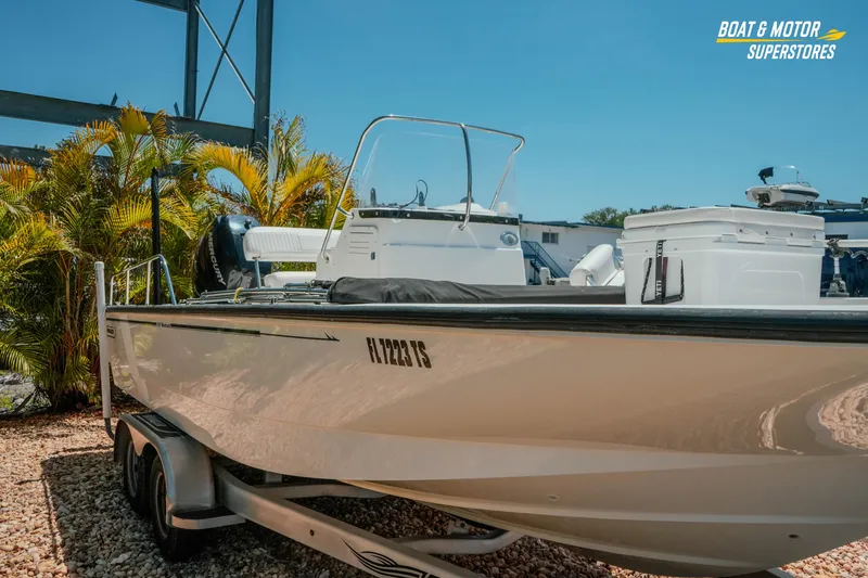 Slide: The Image of 2016 Boston Whaler 210 Montauk boat on trailer, parked outdoors near palm trees. - 5