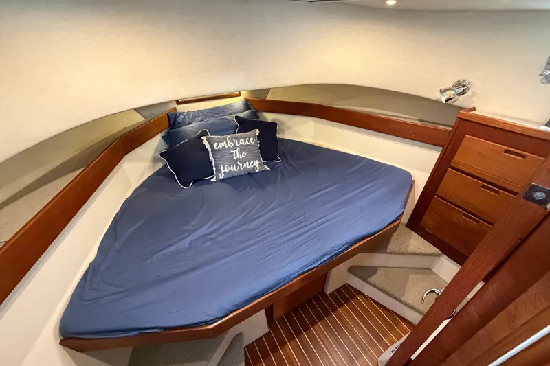 Slide: The Image of Cozy cabin interior of 2007 Nordic Tug 32 with blue bedding and wooden accents. - 10