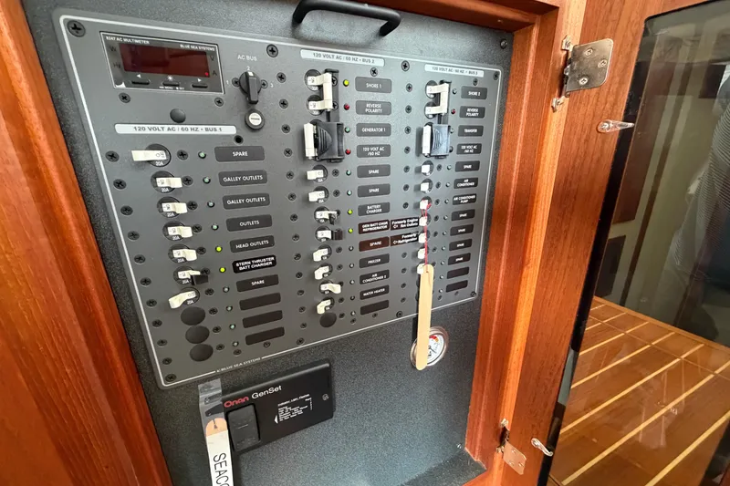 Slide: The Image of Electrical panel of a 2007 Nordic Tug 32 boat, featuring various switches and controls. - 17