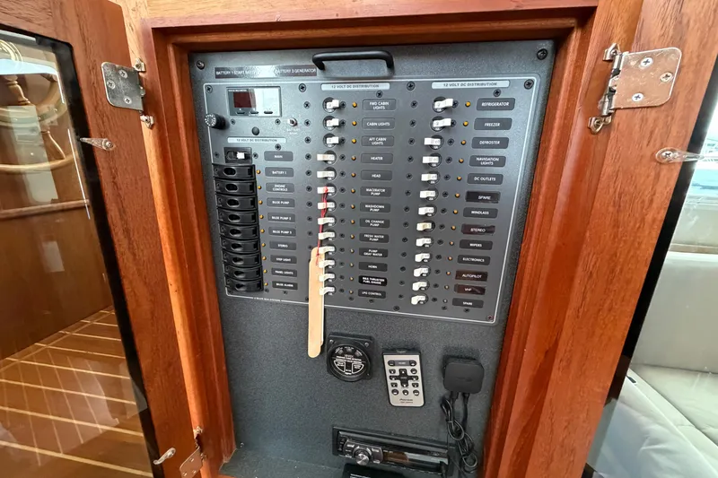 Slide: The Image of Electrical panel inside a 2007 Nordic Tug 32 boat, featuring various switches and controls. - 18