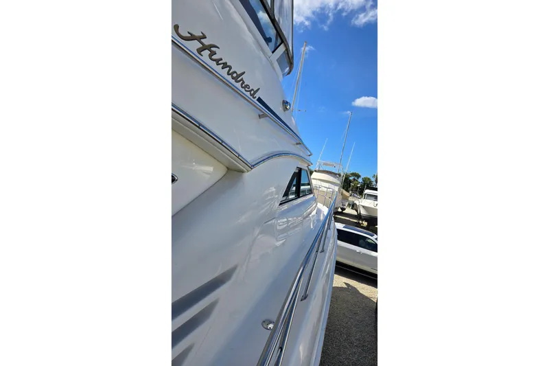 Slide: The Image of Luxurious cabin interior of 2001 Sea Ray 400 Sedan Bridge yacht with cozy bed and wooden cabinetry. - 15