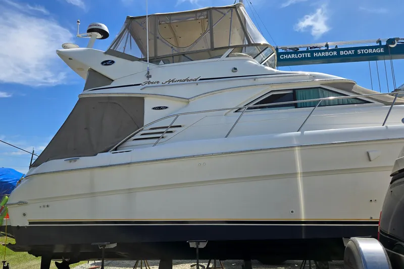Slide: The Image of 2001 Sea Ray 400 Sedan Bridge yacht on dry dock under clear blue sky. - 18