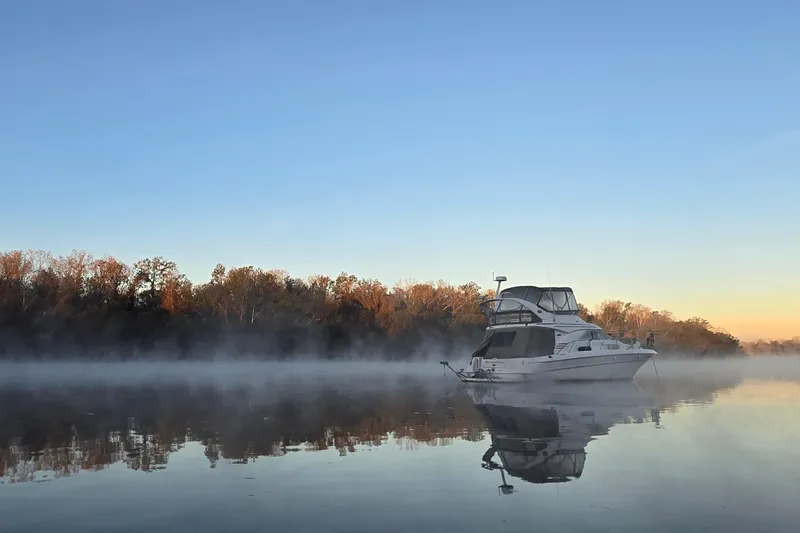 Slide: The Image of 2001 Sea Ray 400 Sedan Bridge boat seating area with beige upholstery. - 19