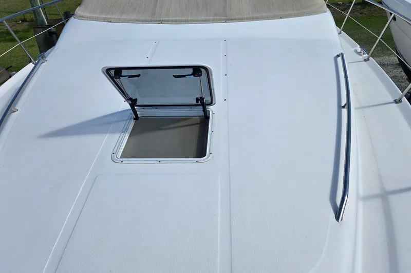 Slide: The Image of 2001 Sea Ray 400 Sedan Bridge yacht in a marina, side view. - 21