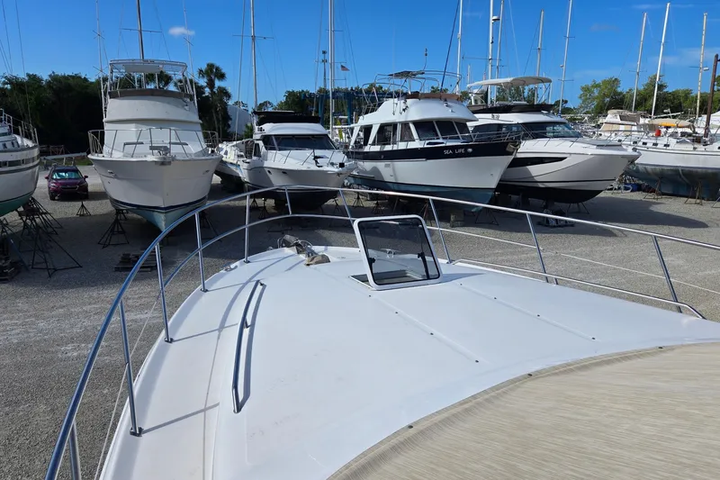 Slide: The Image of 2001 Sea Ray 400 Sedan Bridge yacht on stands, hull view, outdoor setting. - 25