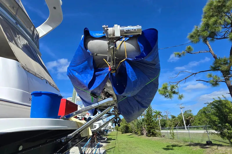 Slide: The Image of 2001 Sea Ray 400 Sedan Bridge yacht with enclosed flybridge, set against a clear blue sky. - 30