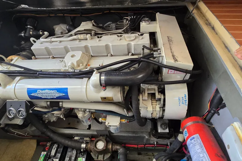 Slide: The Image of Open hatch on 2001 Sea Ray 400 Sedan Bridge, revealing storage compartment and handle. - 32