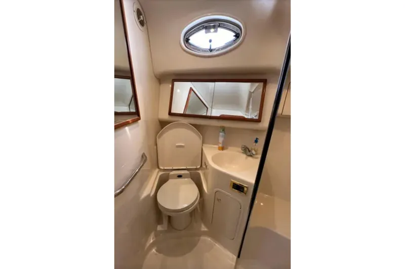 Slide: The Image of Bathroom interior of 2001 Sea Ray 400 Sedan Bridge yacht, featuring toilet and sink. - 39