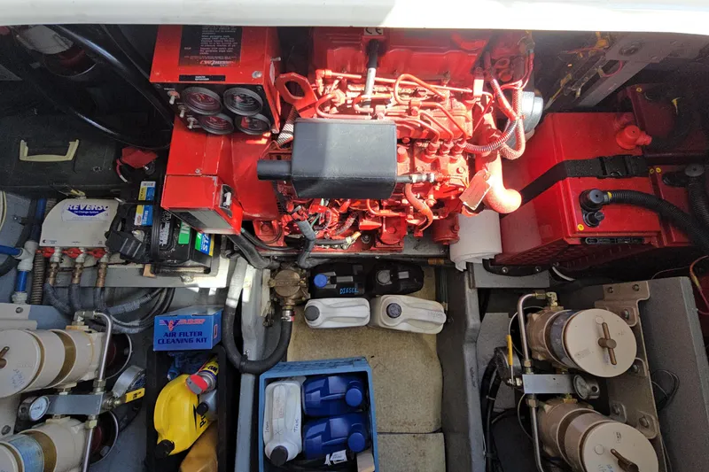 Slide: The Image of Engine compartment of a 2001 Sea Ray 400 Sedan Bridge with visible components and equipment. - 54