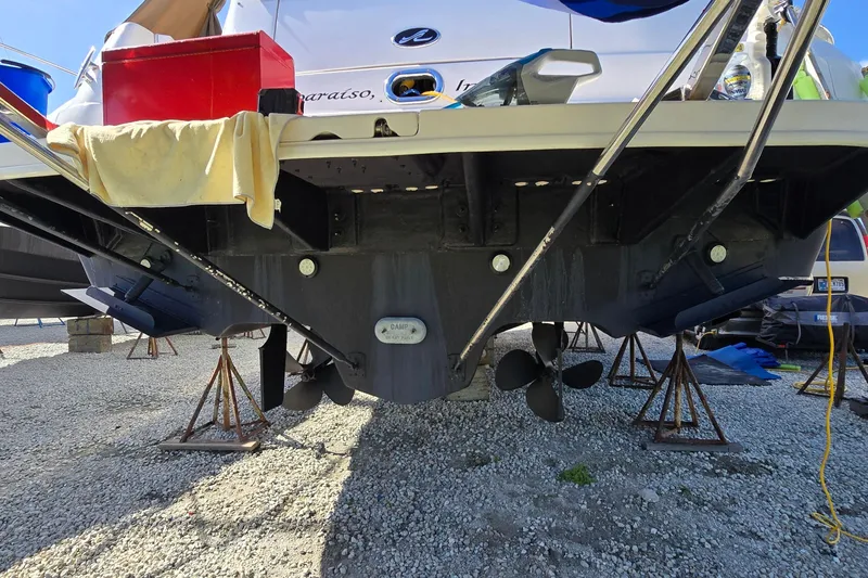 Slide: The Image of 2001 Sea Ray 400 Sedan Bridge on stands, showing propellers and hull details. - 57