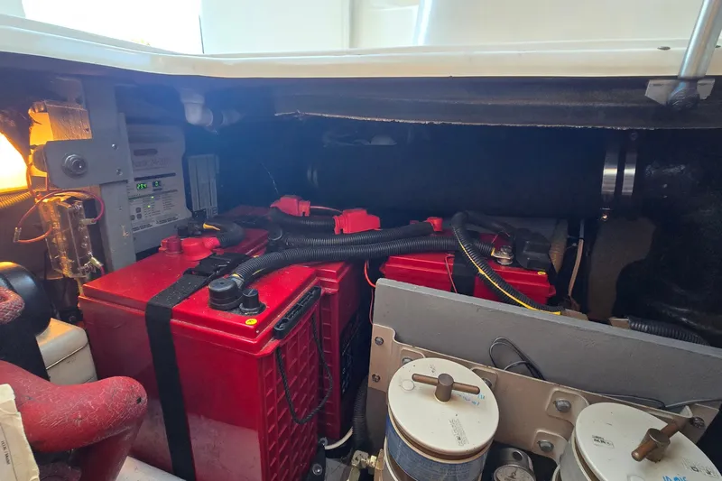 Slide: The Image of Engine room of a 2001 Sea Ray 400 Sedan Bridge with red batteries and wiring. - 61