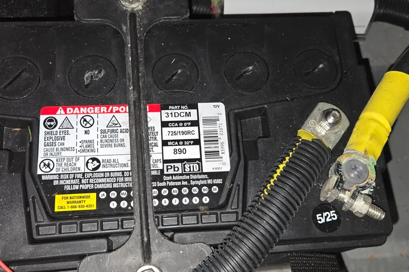 Slide: The Image of Battery compartment of a 2001 Sea Ray 400 Sedan Bridge with safety warnings and yellow cable. - 62