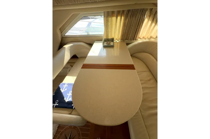 Slide: The Image of Interior of 2001 Sea Ray 400 Sedan Bridge yacht with elegant dining area and nautical decor. - 63