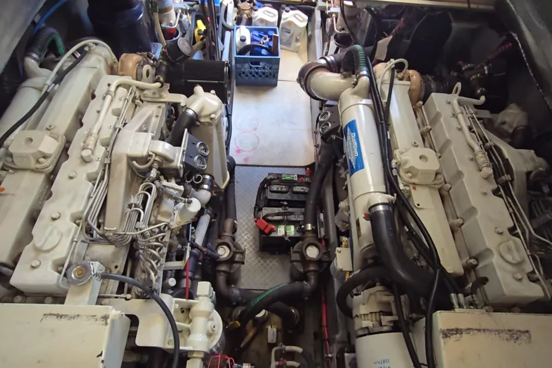 Slide: The Image of Engine room of a 2001 Sea Ray 400 Sedan Bridge with visible machinery and components. - 64