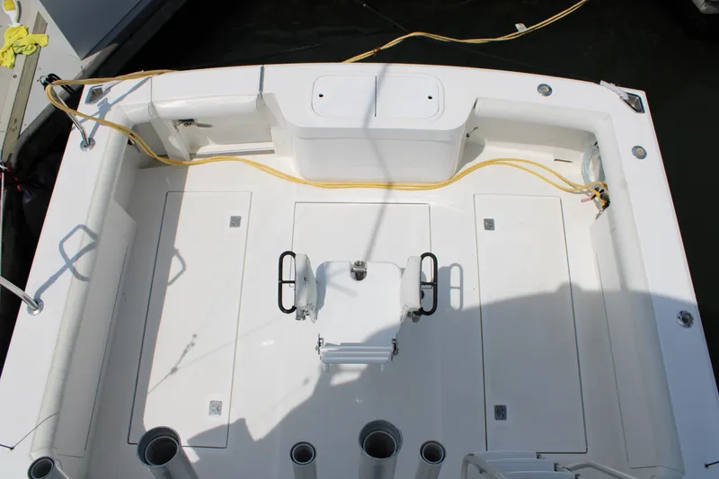 Slide: The Image of 2001 Cabo 35 Flybridge boat deck with fishing chair and storage compartments. - 11