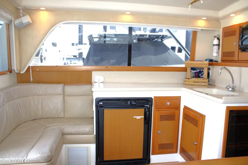 Slide: The Image of Interior of 2001 Cabo 35 Flybridge yacht with kitchenette and seating area. - 14