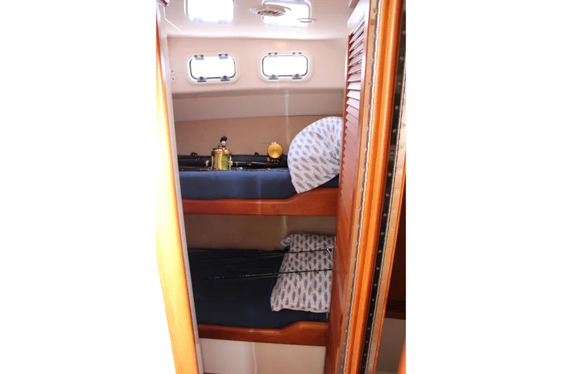 Slide: The Image of Interior of 2001 Cabo 35 Flybridge with bunk beds and nautical decor. - 17