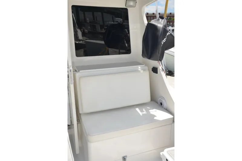 Slide: The Image of 2001 Cabo 35 Flybridge interior with cushioned seating and window view. - 20