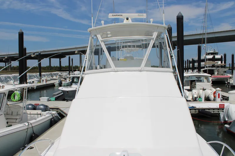 Slide: The Image of 2001 Cabo 35 Flybridge boat docked at marina under clear blue sky. - 3