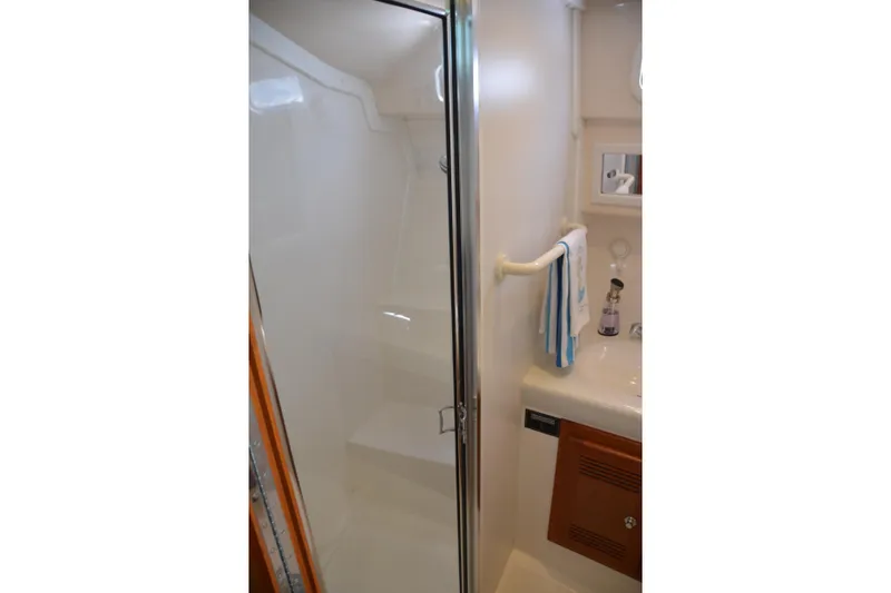 Slide: The Image of Bathroom interior of 2001 Cabo 35 Flybridge yacht with shower and sink. - 37