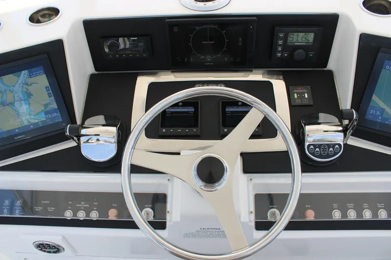 Slide: The Image of Helm of 2001 Cabo 35 Flybridge with navigation screens and controls. - 6