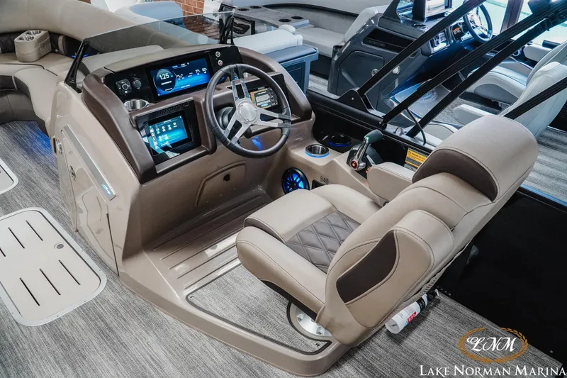 Slide: The Image of Interior of 2026 Bennington 24LXSSB boat with modern dashboard and luxurious seating. - 12