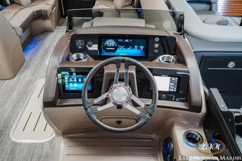 Slide: The Image of 2026 Bennington 24LXSSB boat dashboard with modern controls and digital displays. - 13