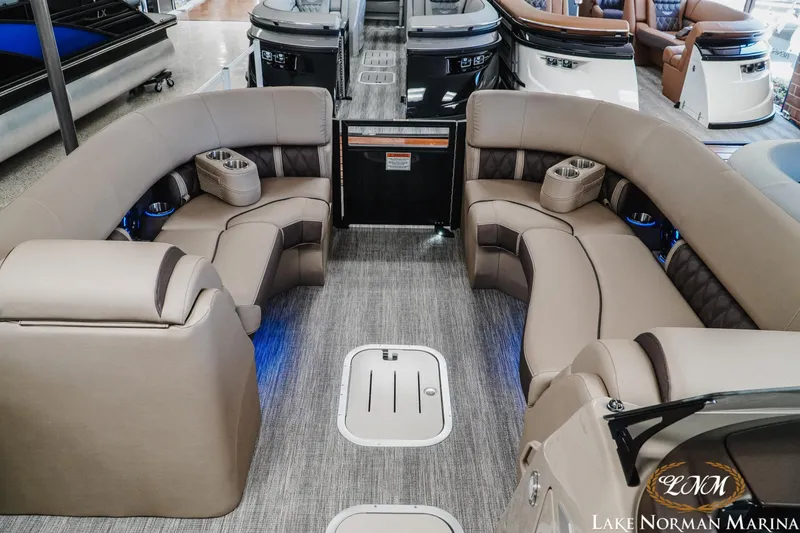 Slide: The Image of Luxurious interior of 2026 Bennington 24LXSSB pontoon boat with plush seating and modern design. - 16