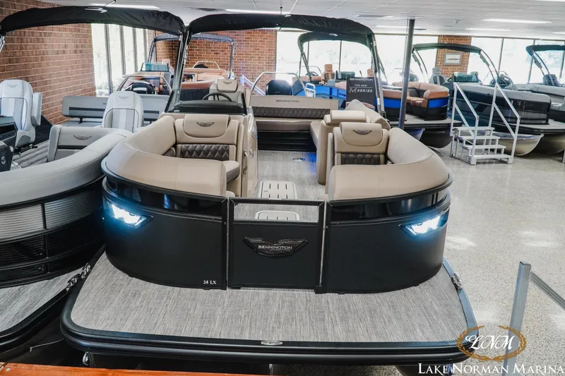 Slide: The Image of 2026 Bennington 24LXSSB pontoon boat displayed at Lake Norman Marina showroom. - 4