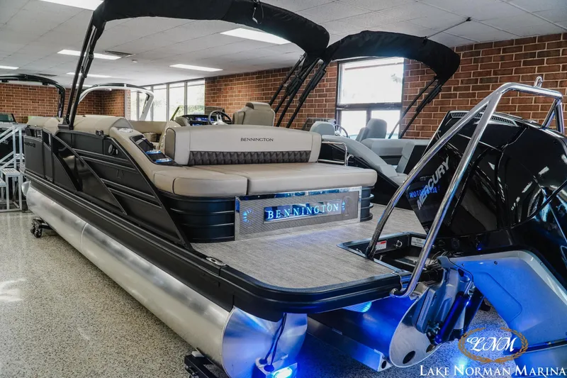 Slide: The Image of 2026 Bennington 24LXSSB pontoon boat displayed indoors at Lake Norman Marina. - 6