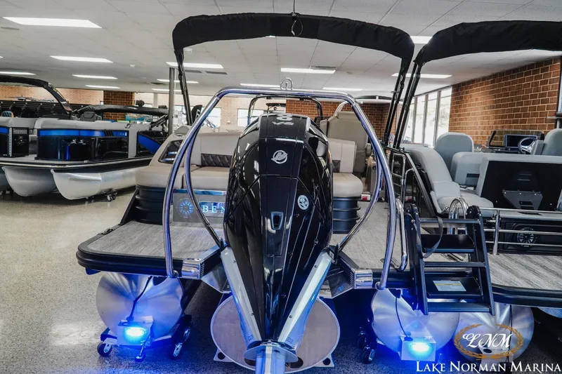 Slide: The Image of 2026 Bennington 24LXSSB pontoon boat displayed indoors at Lake Norman Marina. - 7
