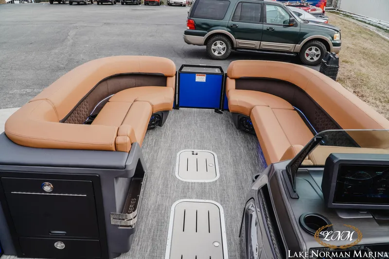 Slide: The Image of 2026 Bennington 24MFB pontoon boat interior with tan seating at Lake Norman Marina. - 11