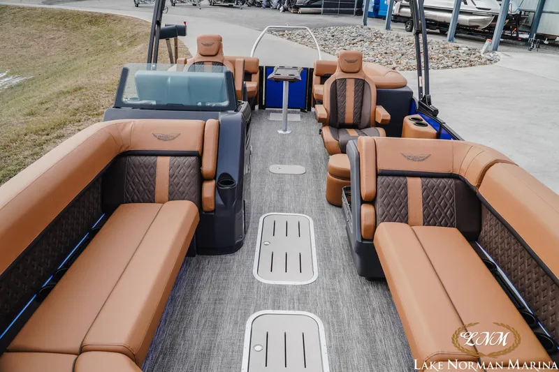 Slide: The Image of Luxurious 2026 Bennington 24MFB pontoon boat interior with plush brown seating at Lake Norman Marina. - 14