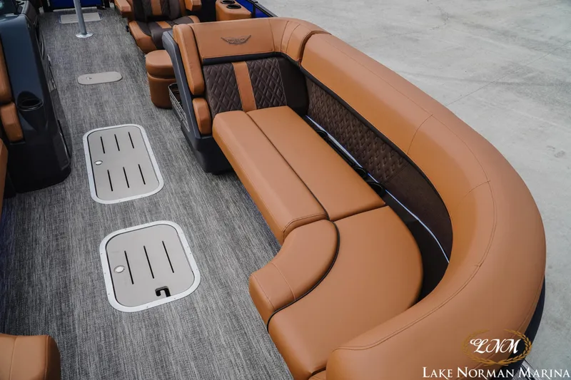 Slide: The Image of 2026 Bennington 24MFB boat interior with luxurious brown seating at Lake Norman Marina. - 16