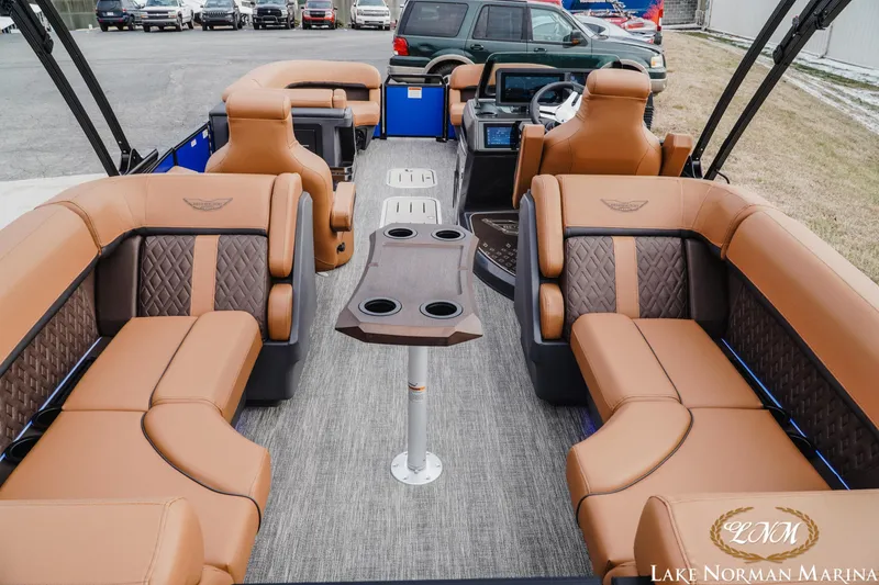 Slide: The Image of Luxurious interior of 2026 Bennington 24MFB pontoon boat with tan seating and modern dashboard. - 4