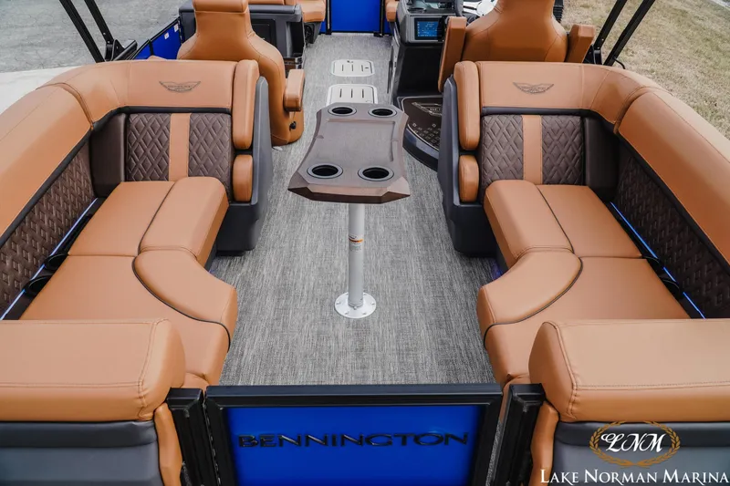 Slide: The Image of 2026 Bennington 24MFB pontoon boat interior with luxurious tan seating and central table. - 5