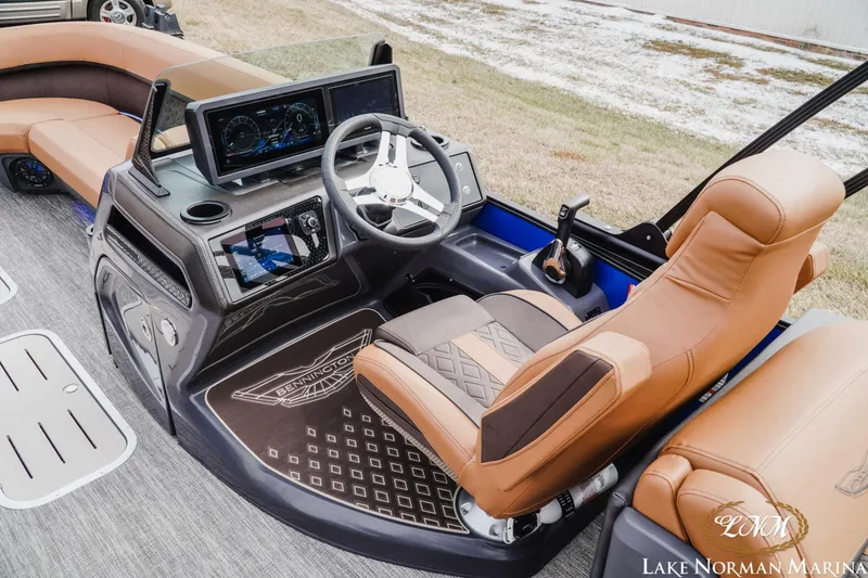 Slide: The Image of Luxurious interior of 2026 Bennington 24MFB boat with advanced dashboard and leather seating. - 9