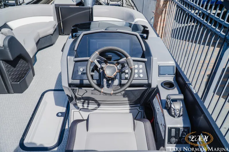 Slide: The Image of Cockpit of 2026 Evotti 723CS boat with modern steering and controls at Lake Norman Marina. - 8