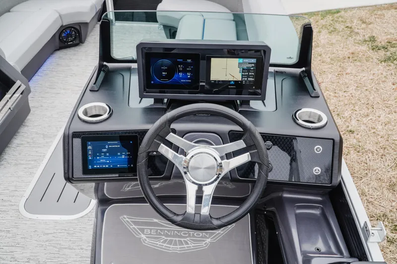 Slide: The Image of 2025 Bennington 24MSB boat dashboard with modern steering and digital displays. - 10
