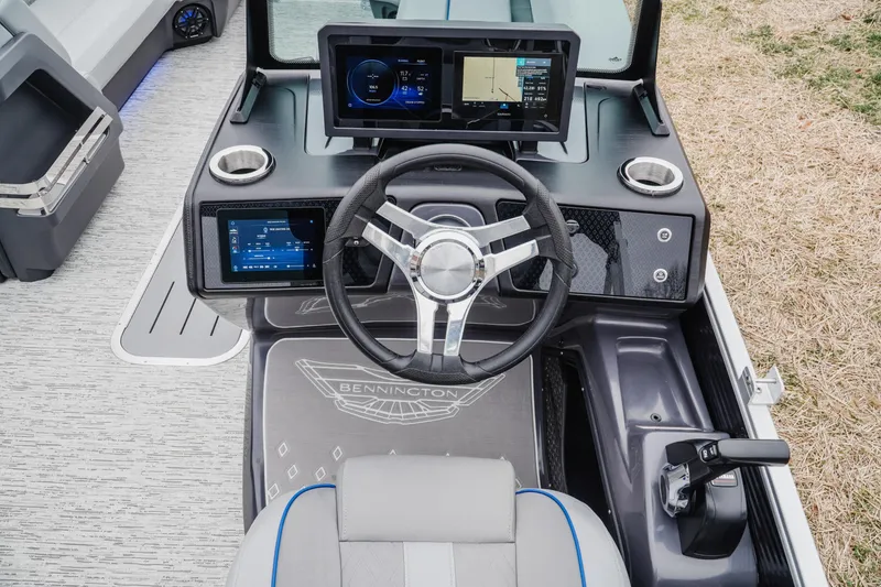 Slide: The Image of 2025 Bennington 24MSB boat dashboard with modern steering and digital displays. - 11