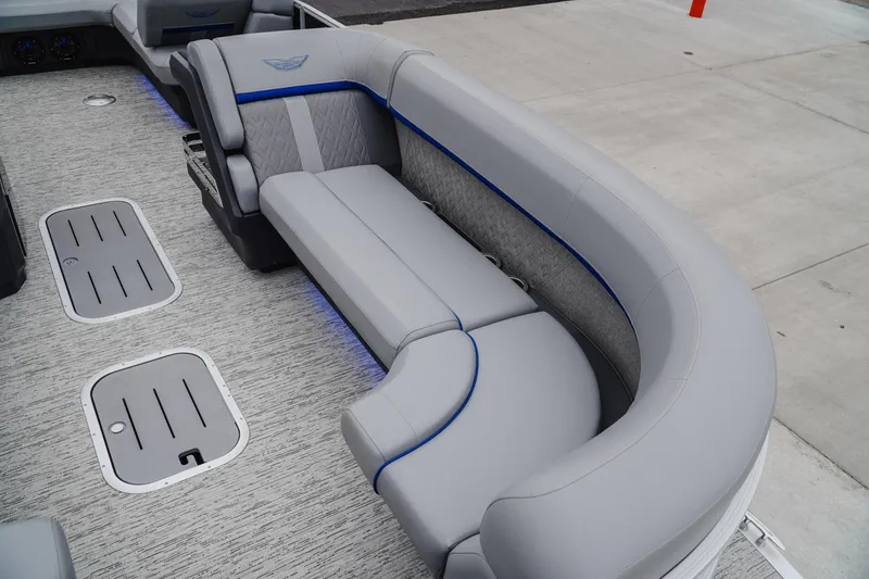 Slide: The Image of 2025 Bennington 24MSB boat interior with gray seating and blue accents. - 16
